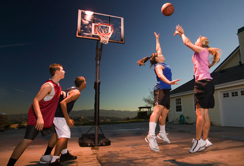 kids playing basketball outdoors