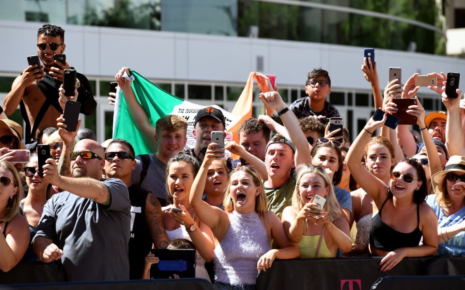 people standing and cheering outdoors Mayweather vs. McGregor fight