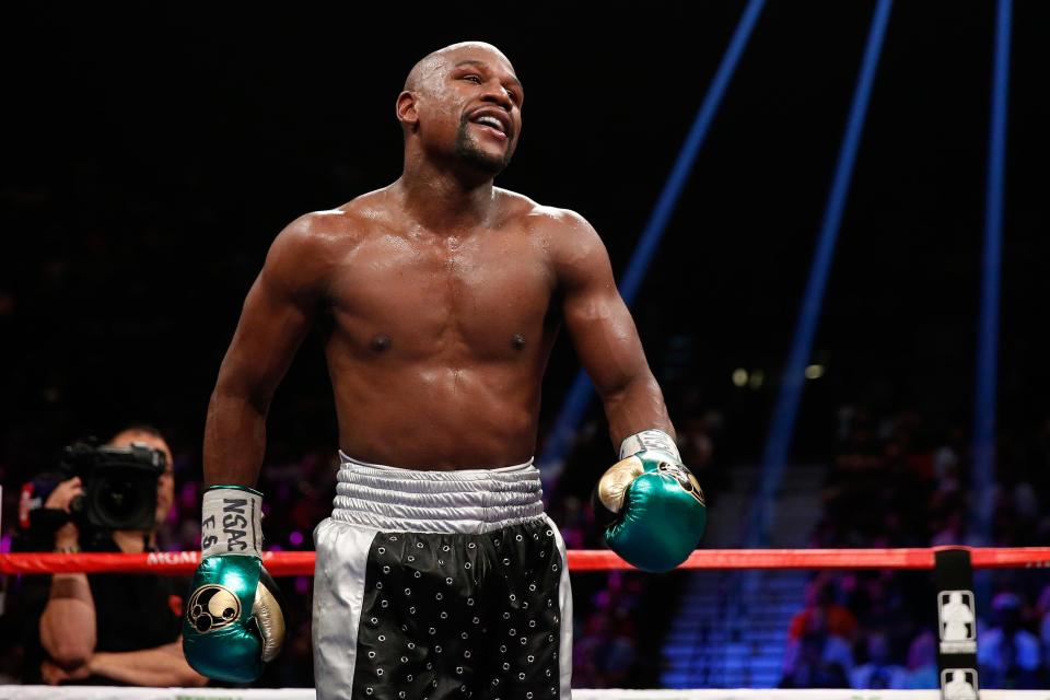 Floyd Mayweather out of Retirement…for MMA Floyd Mayweather smiles standing inside a boxing ring