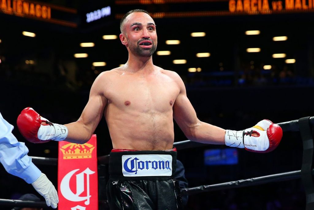 Paulie Malignaggi standing inside a boxing ring