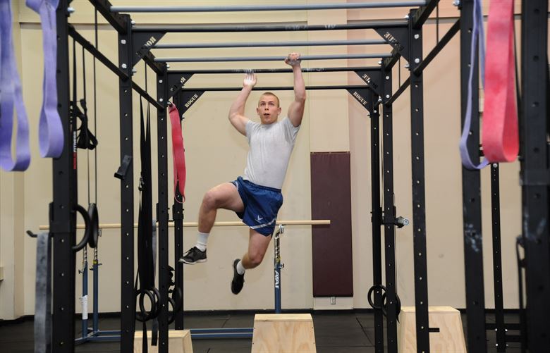 5 Muscle Building Exercises Using Pull Up Bar Man climbing on pull up bars