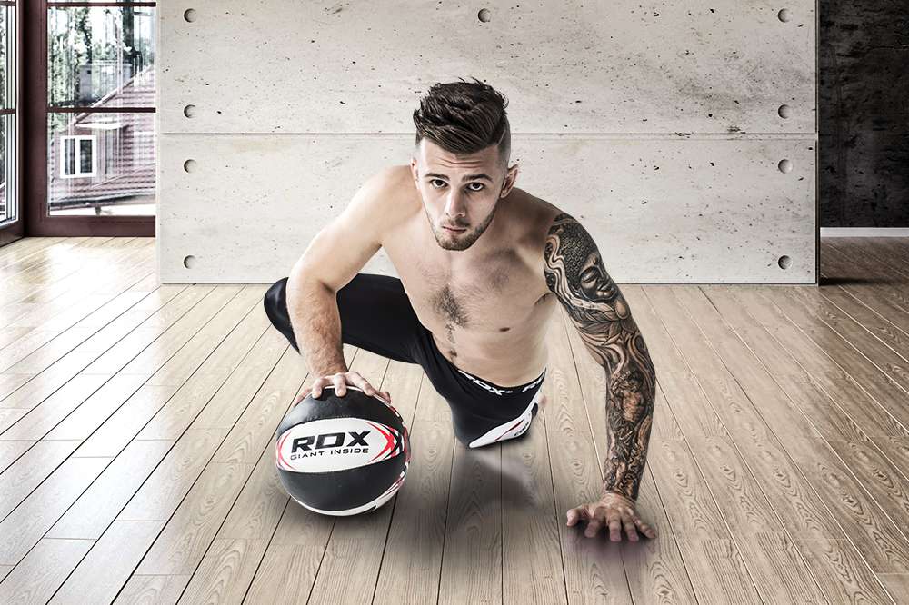 man holding RDX Medicine Ball