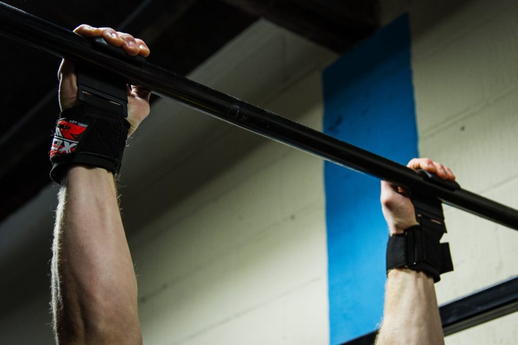 How To Install Pull Up Bar In 5 Easy Steps two hands holding a pull up bar