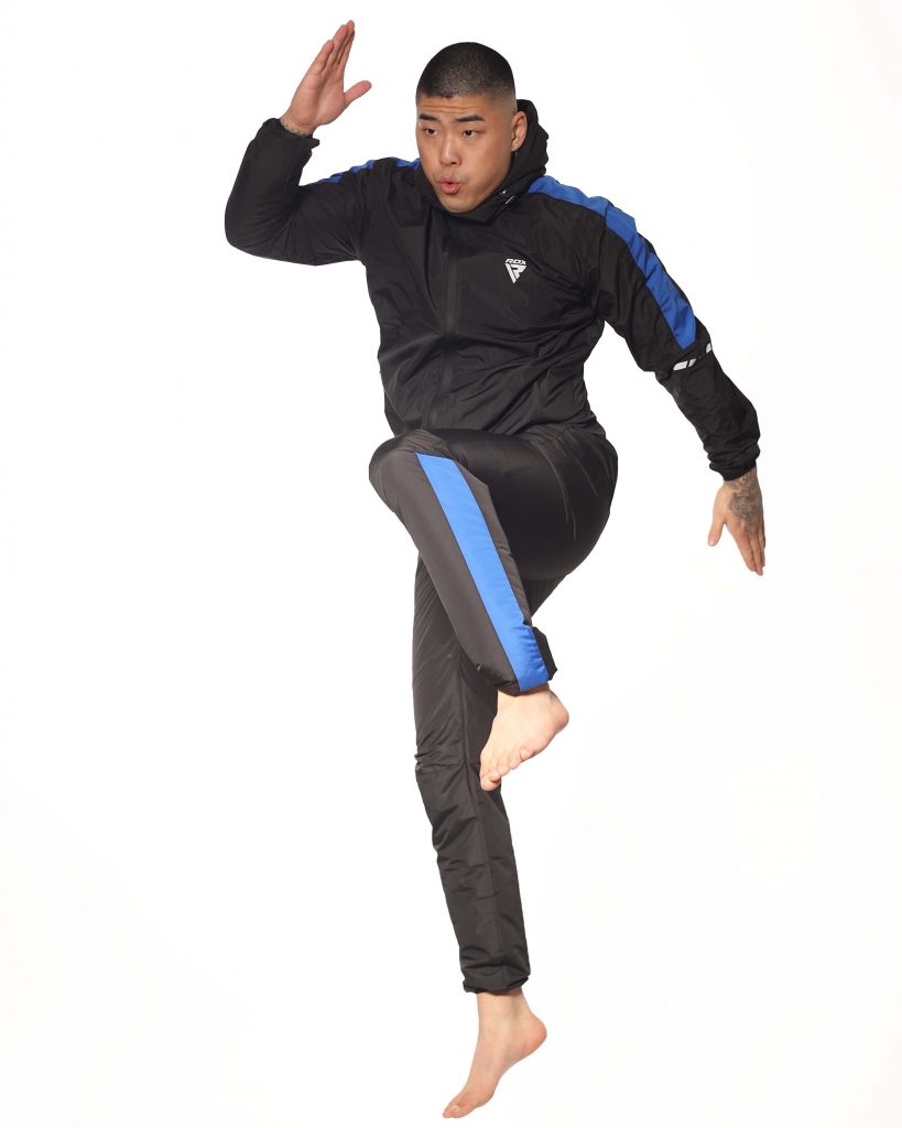 Samuel performing exercises in sauna suits